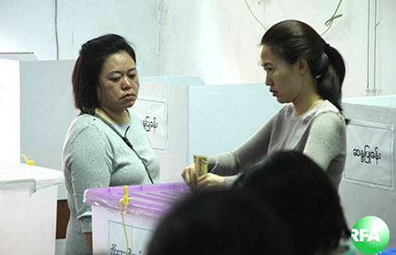A woman casts her vote at a polling station in Myanmar, Sunday, Nov. 8, 2015.