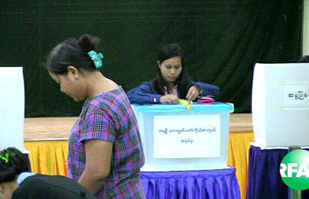 A woman casts her vote at a polling station in Myanmar, Sunday, Nov. 8, 2015. 