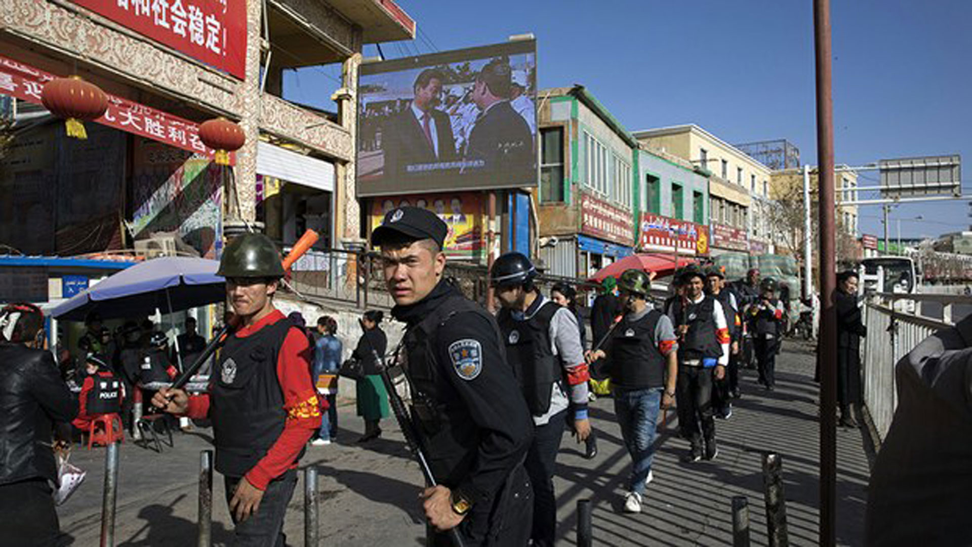 Armed civilians patrol the area outside the bazaar in the seat of Hotan prefecture, Nov. 3, 2017. Photo: AP