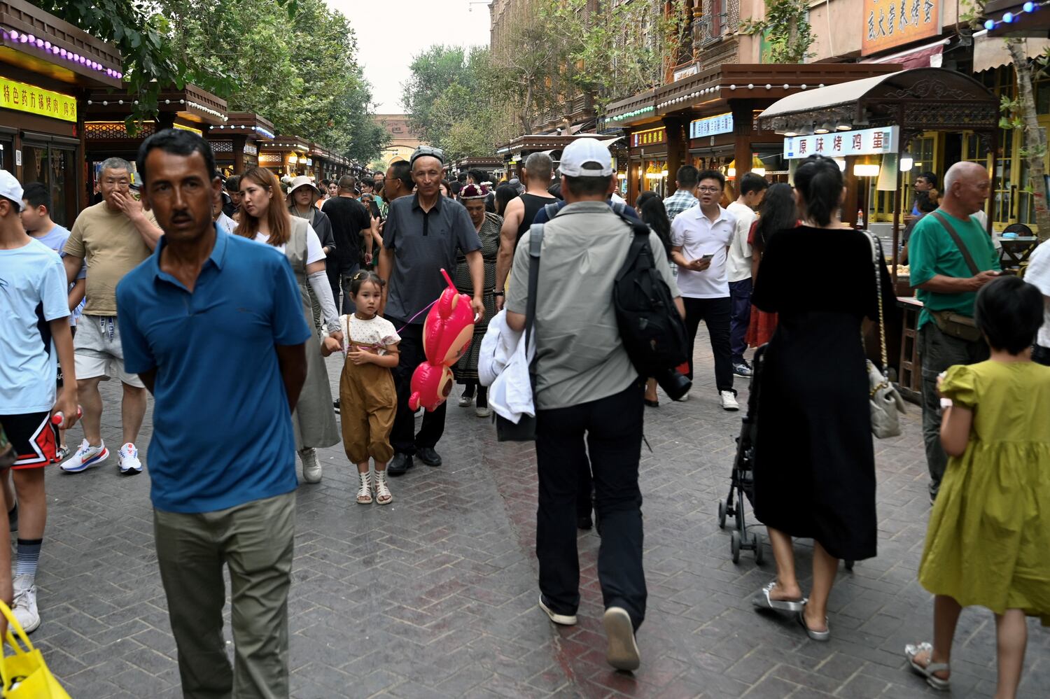 People walk through the Old Kashgar area in China’s northwestern Xinjiang region as part of the government’s effort to establish tourism in the region, July 20, 2033. (Pedro Pardo/AFP)