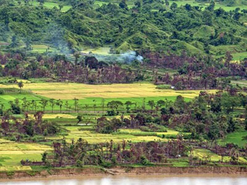 Smoke billows from a burned village near Maungdaw township in Myanmar's volatile northern Rakhine state, Sept. 27, 2017.
