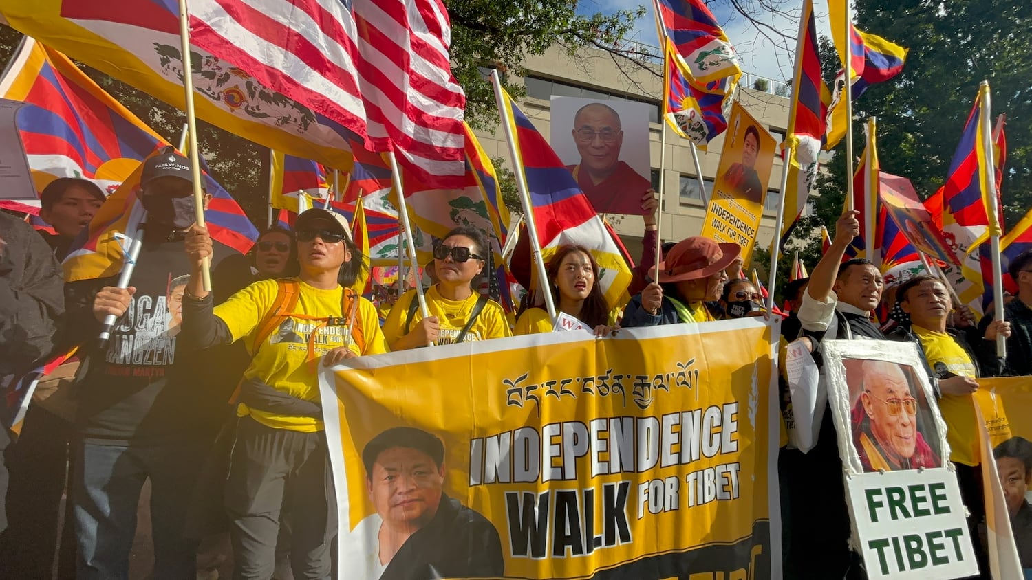 Activists for Tibet carry a banner with the image of Lobga Rangzen as they protest near the Chinese Embassy in Washington, Sept. 24, 2026.