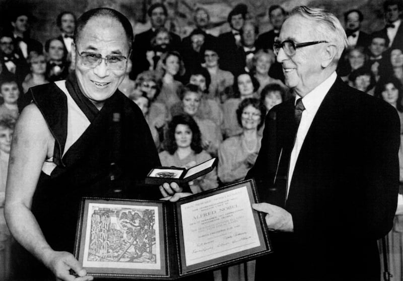 The Dalai Lama  receives the 1989 Nobel Peace Prize from Egil Aarvik, chairman of the Norwegian Nobel Committee Dec. 10, 1989.
