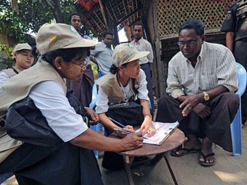 An ethnic Kaman man (R) answers questions as census enumerators take data in Bumay village on the outskirts of Sittwe, western Myanmar's Rakhine state, March 31, 2014.