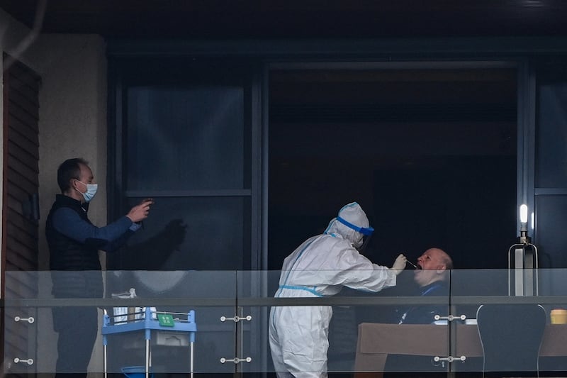 Peter Daszak, a member of the World Health Organization team investigating the origins of COVID-19, gives a swab sample on the balcony of a hotel in Wuhan, China, on Feb. 6, 2021.