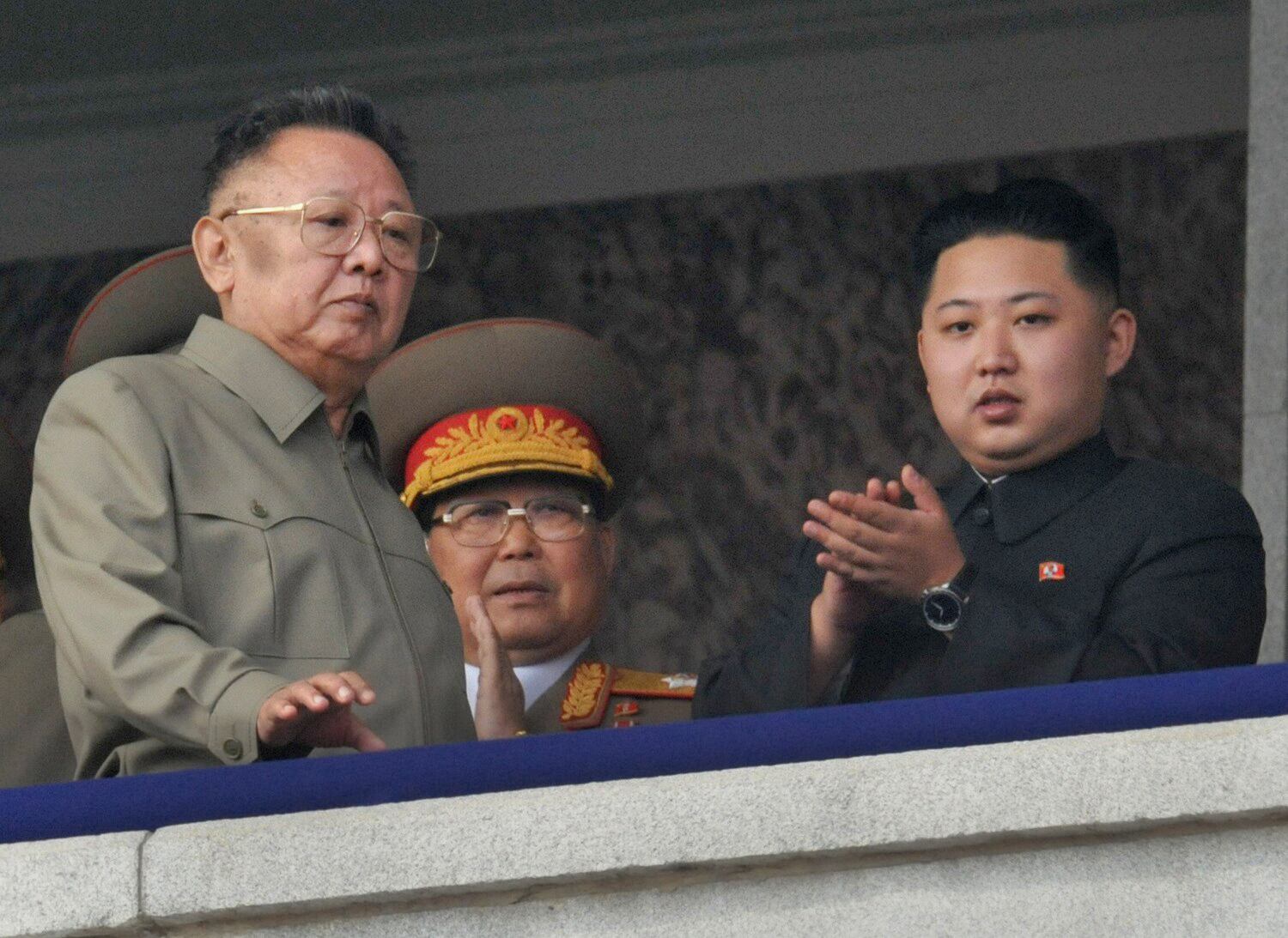 North Korea's National Defense Commission Chairman Kim Jong-il, left, and his son Kim Jong-un, right, watch  a parade commemorating the 65th anniversary of the founding of the Workers' Party of Korea in Pyongyang, Oct.10, 2010.
