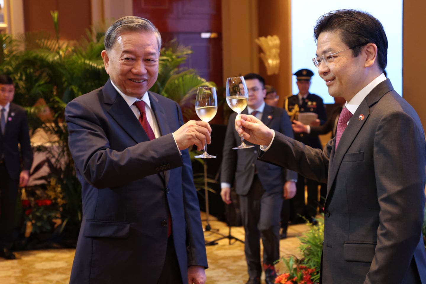Communist Party of Vietnam General Secretary To Lam (L) and Singapore Prime Minister Lawrence Wong make a toast during Lam’s visit to the city state on March 12, 2025.