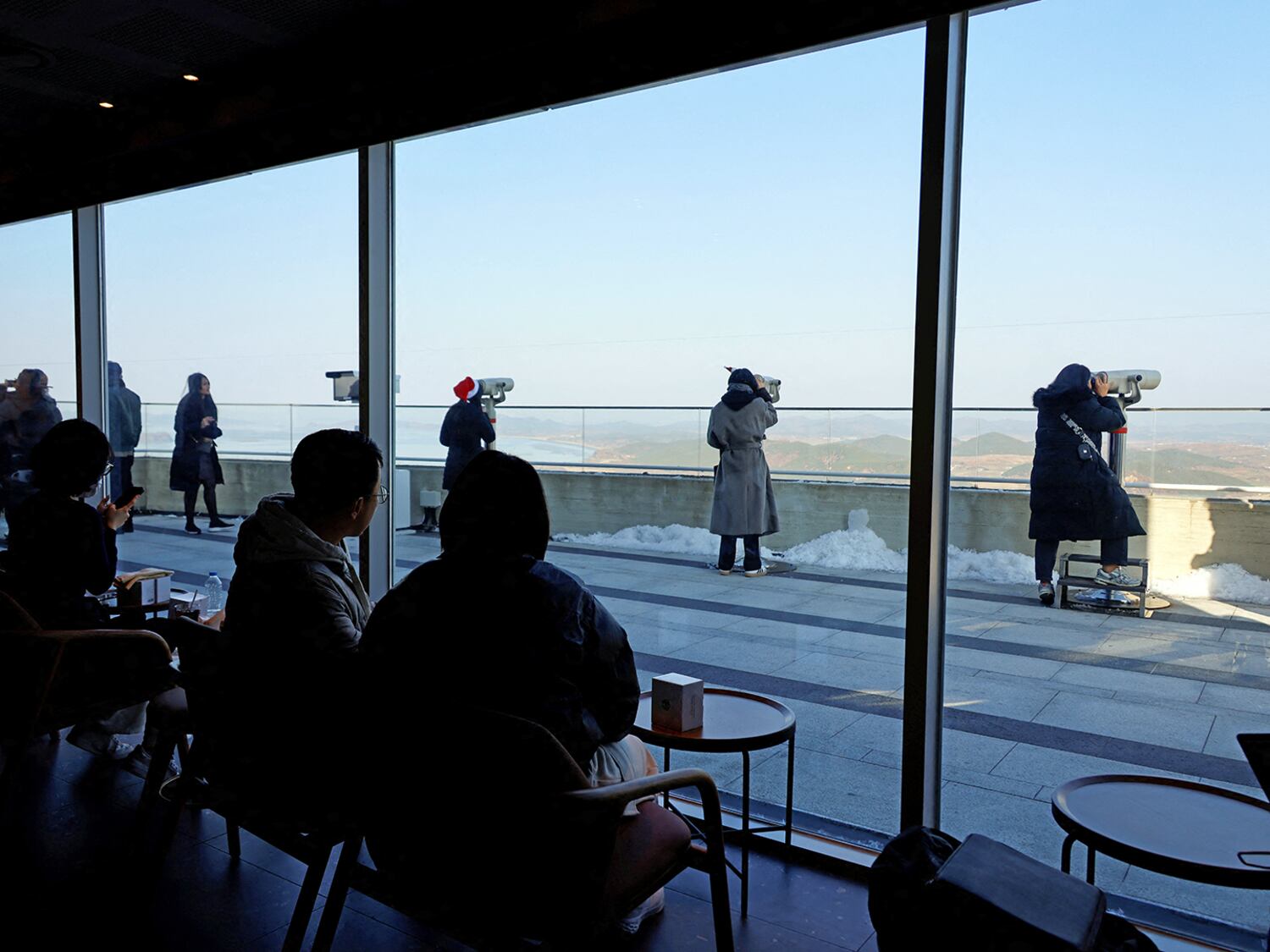 Customers sit in the Starbucks at the top of the Aegibong Peak Observatory, south of the demilitarized zone (DMZ), separating the two Koreas in Gimpo, South Korea, Nov. 29, 2024.
