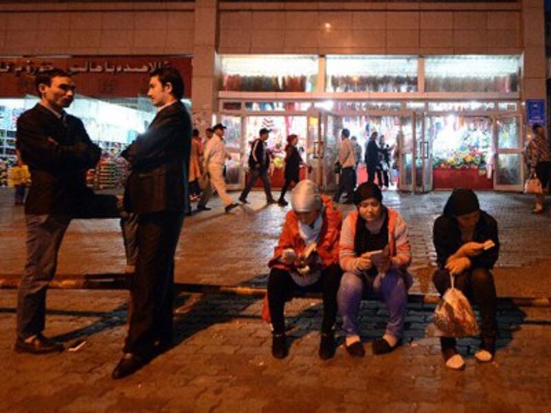 Young Uyghurs rest near the Grand Bazaar in Urumqi, Sept. 17, 2014.