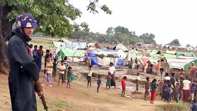 A security guard stands by a camp near the Rakhine state capital Sittwe for Rohingyas displaced by ethnic violence in 2012, in file photo.