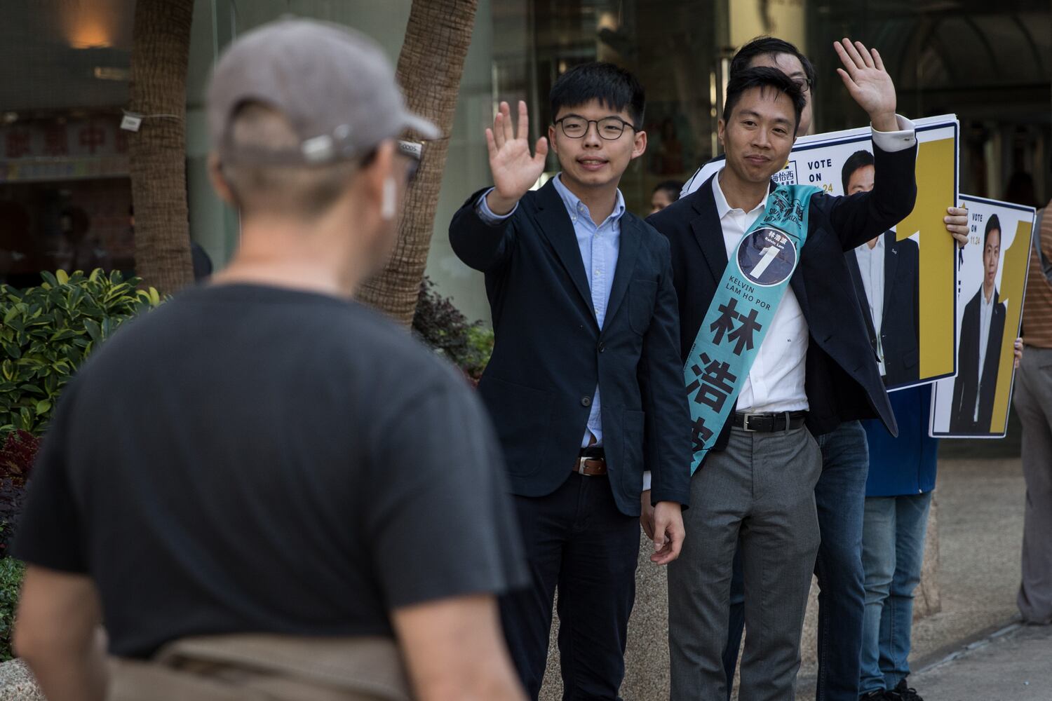 Joshua Wong, center,  campaigns with his replacement candidate Kelvin Lam on November 23, 2019 in Hong Kong. (Chris McGrath/Getty Images)