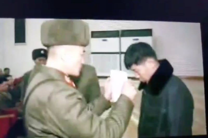 Footage of a North Korean educational propaganda video shows a North Korean soldier reading an arrest warrant in front of a soldier who was caught illegally watching foreign media.