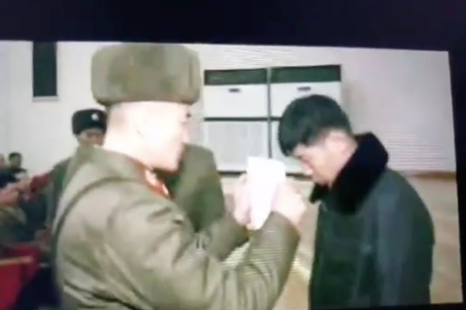 Footage of a North Korean educational propaganda video shows a North Korean soldier reading an arrest warrant in front of a soldier who was caught illegally watching foreign media.