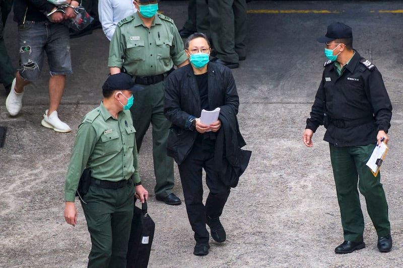 Hong Kong pro-democracy activist Benny Tai (C) walks towards a Hong Kong Correctional Services van at the Lai Chi Kok Reception Centre where he was taken after appearing at the West Kowloon Court the day before on the charge of conspiracy to commit subversion, in Hong Kong, March 2, 2021. (Vernon Yuen/AFP)