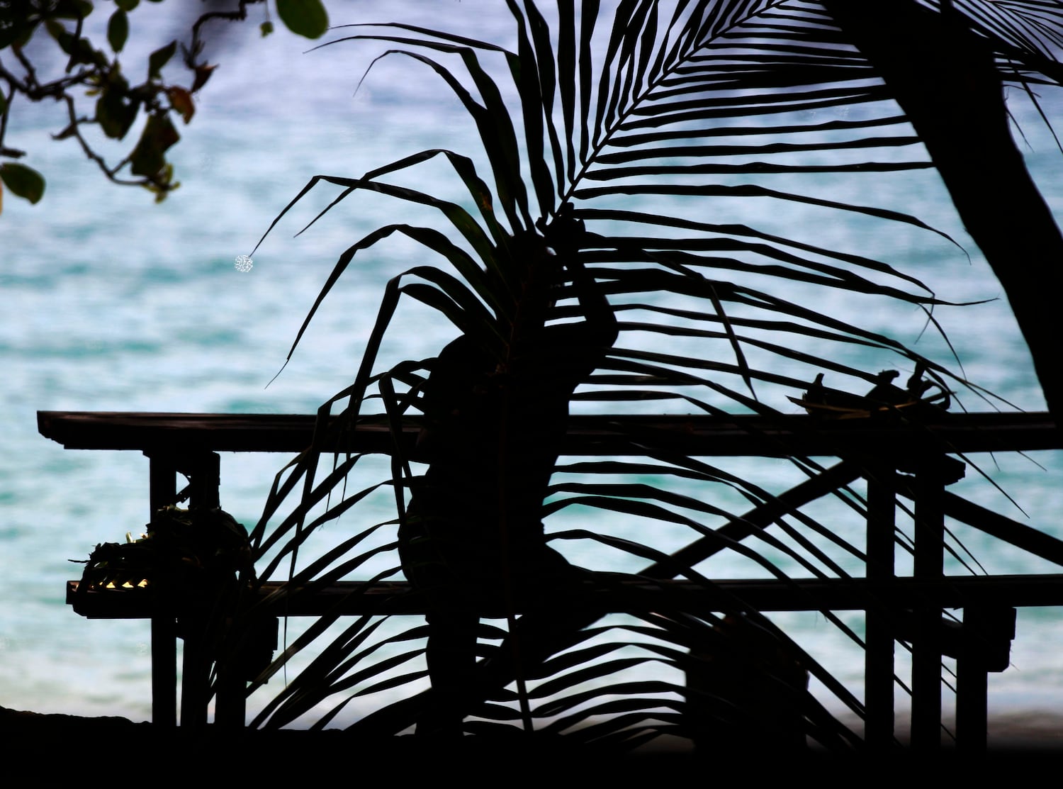 In this September 15, 2012 photo, a woman makes dishes out of palm leaves at Bonegi Beach in Honiara.