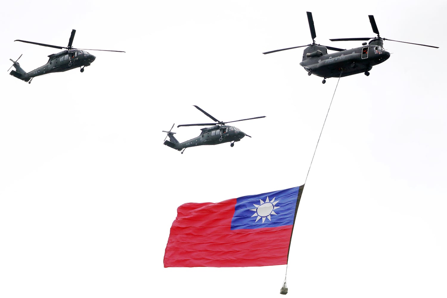 Military helicopters fly over with Taiwan national flag during the inauguration celebration of Taiwan's President Lai Ching-te in Taipei, Taiwan, May 20, 2024.