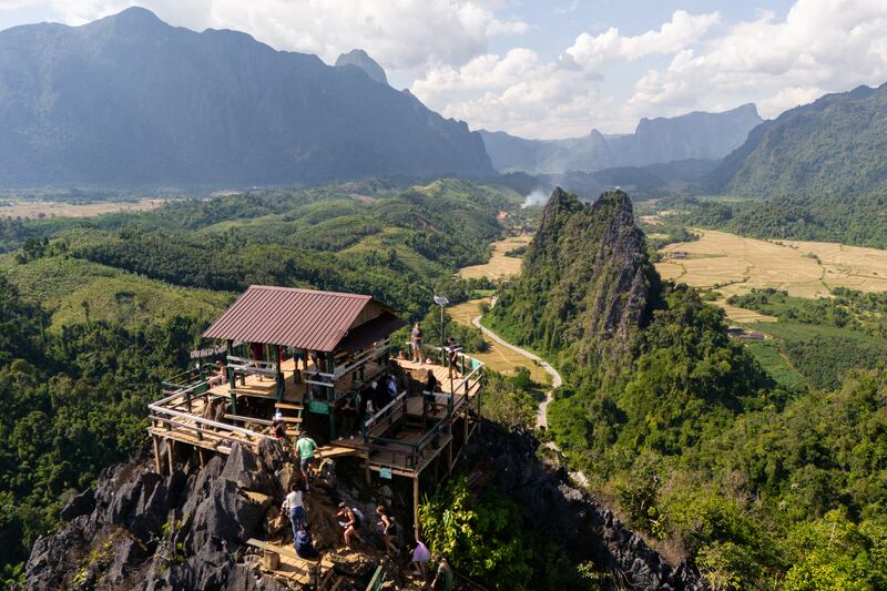 Tourists look at the surroundings from Namxay Viewpoint in Vang Vieng, Nov. 24, 2024.