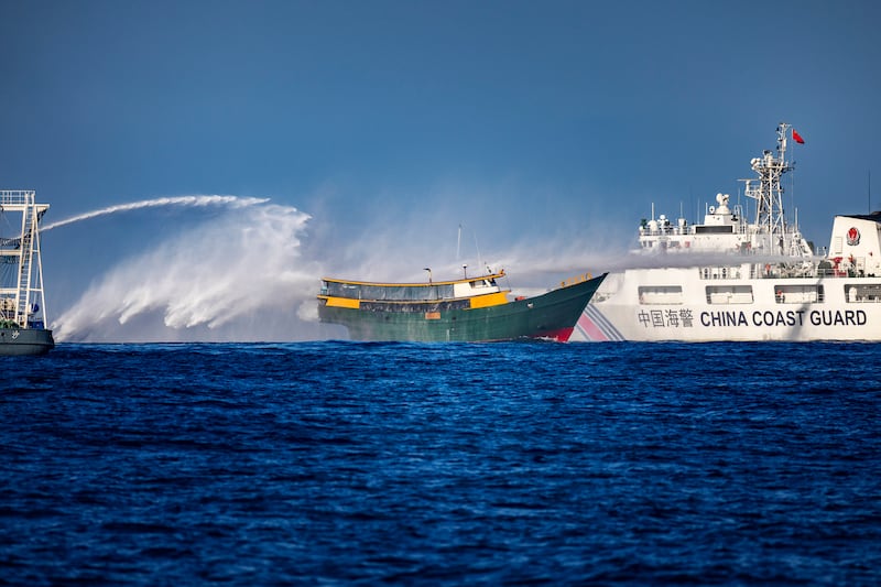 A Chinese Coast Guard ship fires a water cannon at Unaizah May 4, a Philippine Navy chartered vessel, conducting a routine resupply mission to troops stationed at Second Thomas Shoal, on March 5, 2024 in the South China Sea.