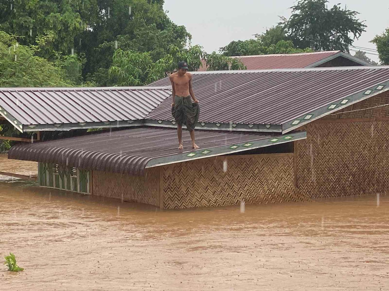 A man is in a house surrounded by flood waters in the village of Kyoet Kone in the canton of Tatkon in Naycyidaw on September 11, 2024 (citizen photo)