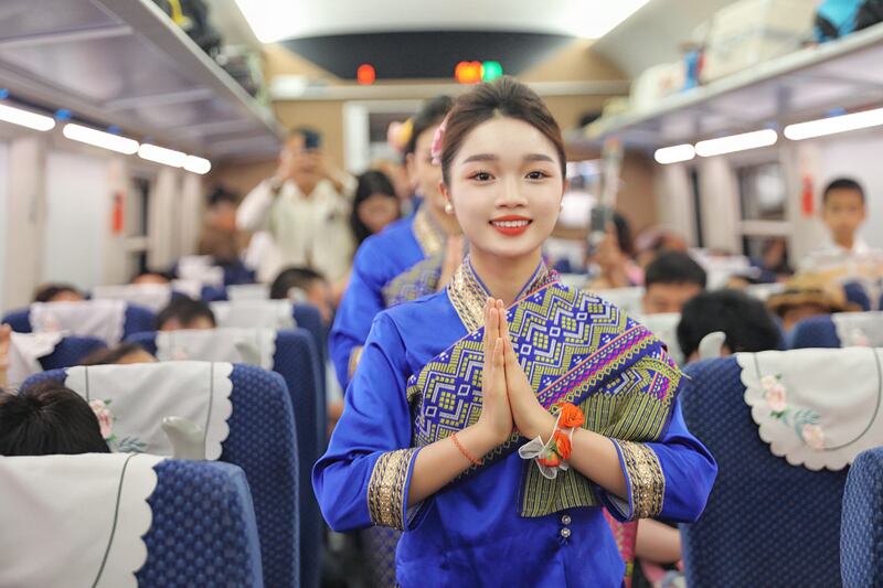 This image released by Chinese government media shows a Lao dance performed for passengers aboard a train from Kunming traveling to Vientiane, July 18, 2025.