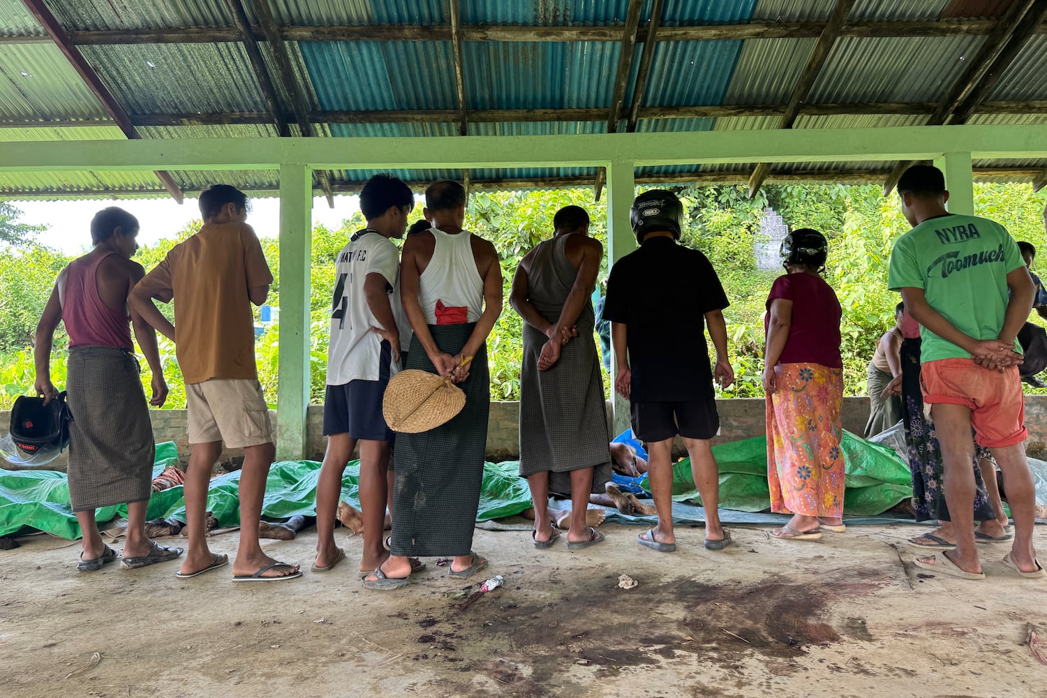 Victim's bodies are laid out at a cemetery before their burial following a military airstrike on a market and adjacent bridge in Kyauktaw, Western Rakhine state, Myanmar, on Sept. 28, 2026.