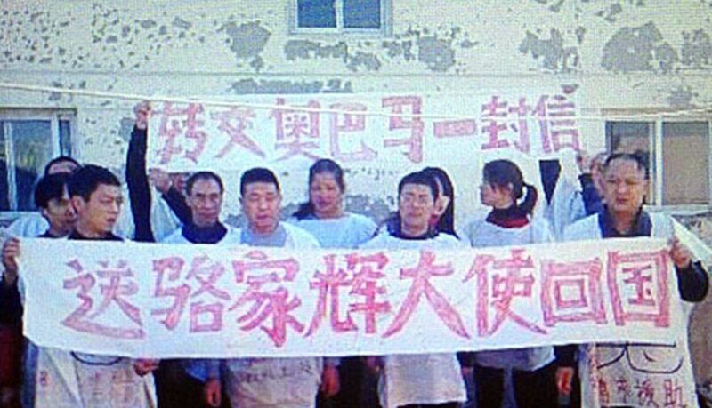 １月9日，重慶廿多名訪民到成都美國總領事館遞請願，他們身穿狀衣，並拉起抗議橫額。（中國天網圖片）