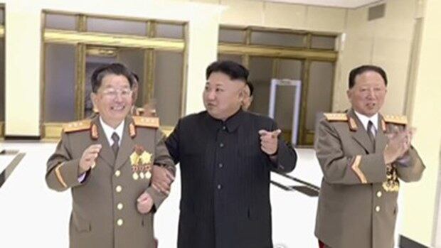 북한 김정은 노동당 위원장이 6차 핵실험에 참여한 핵 과학자·기술자를 위한 축하연회에 참석했다고 조선중앙TV가 보도했다. 사진은 리홍섭 핵무기연구소 소장과 팔짱을 끼고 연회장으로 들어서는 김정은 위원장의 모습. 김 위원장의 오른쪽은 홍승무 당 군수공업부 부부장.