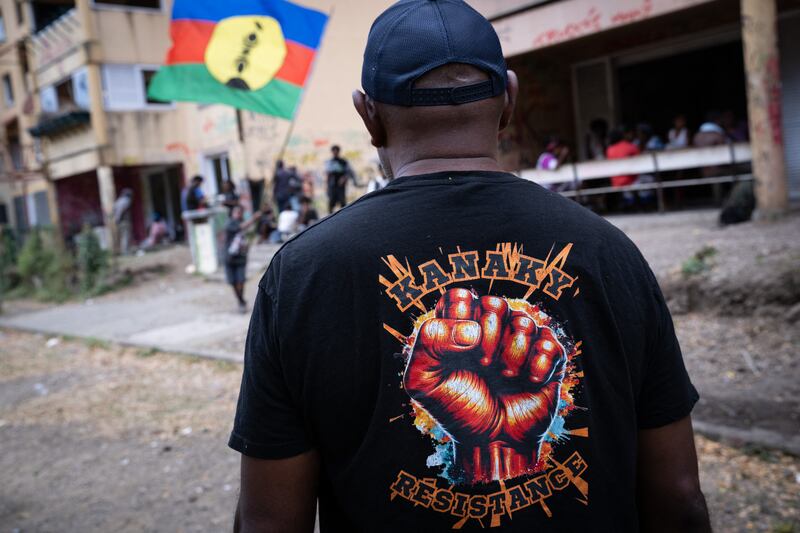 A man with a tshirt reading "Kanaky resistance" looks on in the Pierre Lenquette district of Noumea, on Sept. 29, 2024.