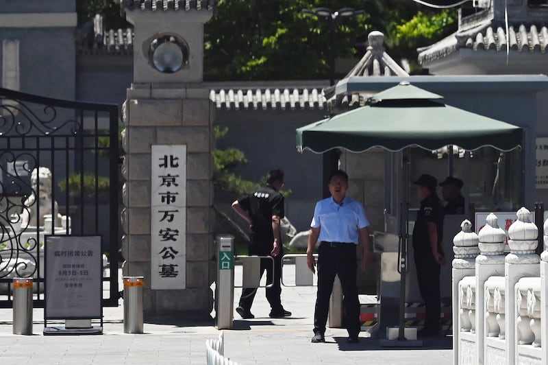 Security guards stand at the entrance to Wan'an cemetery where victims of the June 4, 1989 crackdown on Tiananmen Square democracy protests are known to be buried, in Beijing on June 4, 2025.