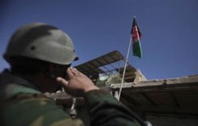 Một quân nhân Afghanistan dưới ngọn cờ chiến thắng. AFP PHOTO.