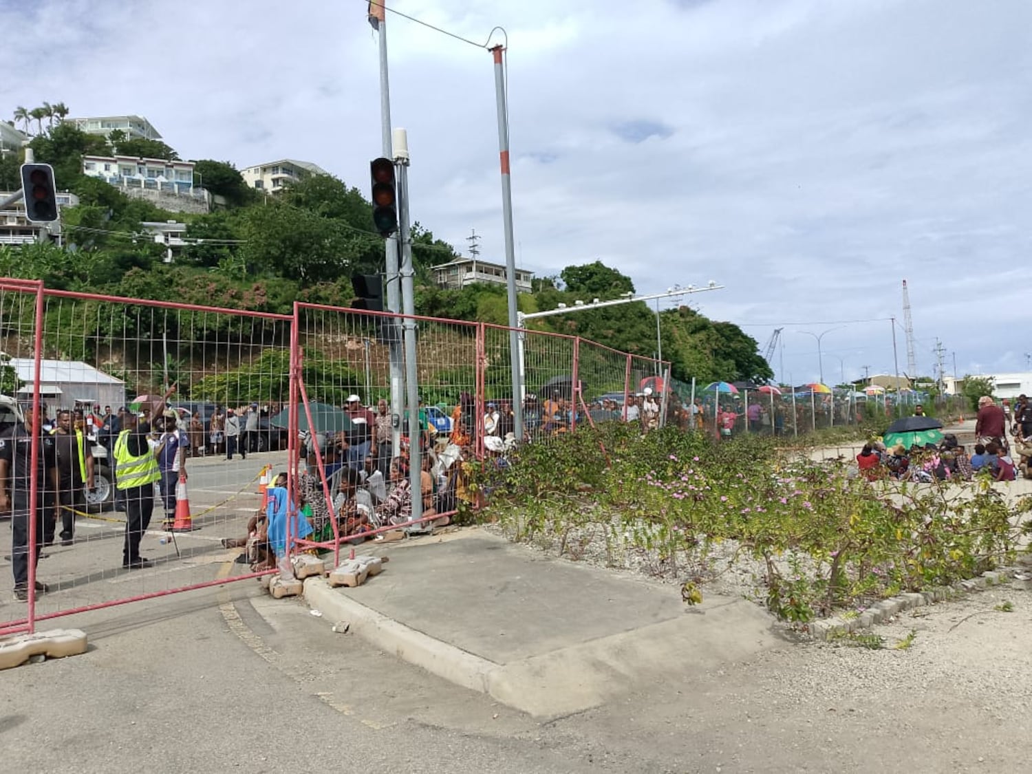 Thousands queue before a security check at Wharf T in Port Moresby, Papua New Guinea, April 11, 2026. After security they will visit triage and might be granted access to the Chinese Navy's Silk Road Ark hospital ship.