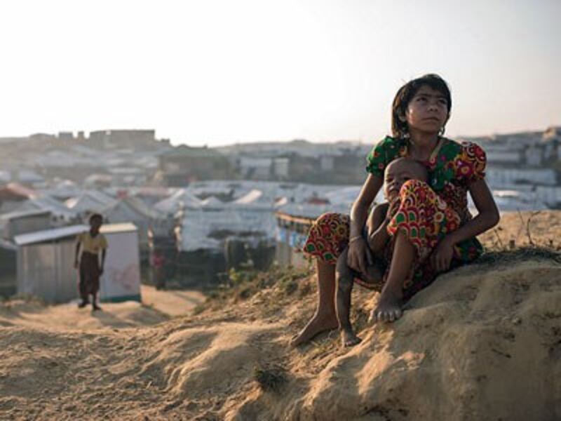 A Rohingya child refugee from Myanmar sits with a baby at the Kutupalong refugee camp in southeastern Bangladesh's Cox's Bazar district, Nov. 27, 2017. 