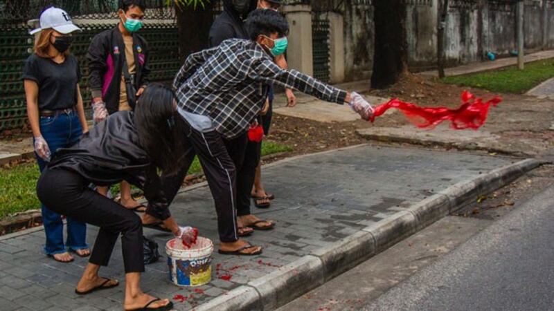 myanmar-protesters-throw-red-paint-yangon-apr6-2021.jpg