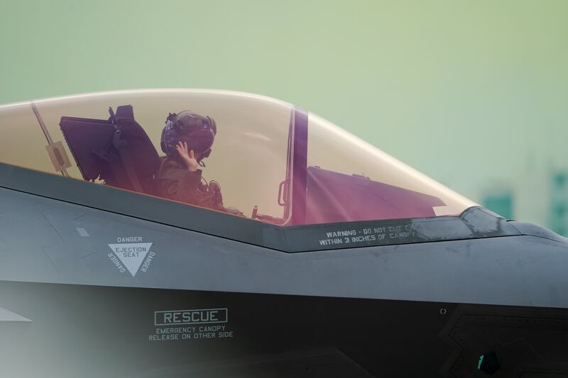 A U.S. Air Force demonstration team pilot waves to spectators before taking off Don Mueang airbase in Bangkok, March 7, 2025.