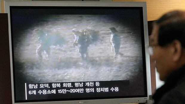 통일전망대에서 한 관광객이 북한 정치범수용소 수감자들에 관한 텔레비젼 보도를 시청하고 있다.