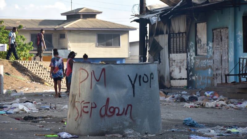 Anti-government messages adorn a burnt-out building in Honiara, Solomon Islands Nov. 27, 2021, after two days of riots.