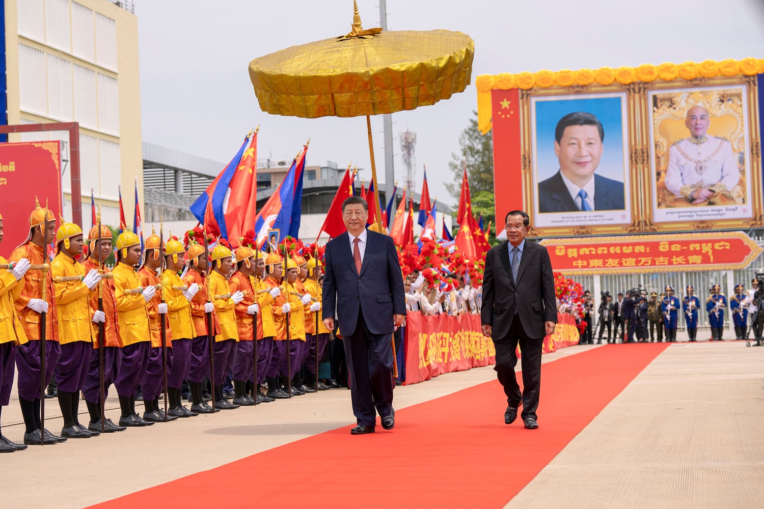 Chinese President Xi Jinping reviews the honor guard with Cambodian Senate President Hun Sen, in Phnom Penh, April 18, 2025.