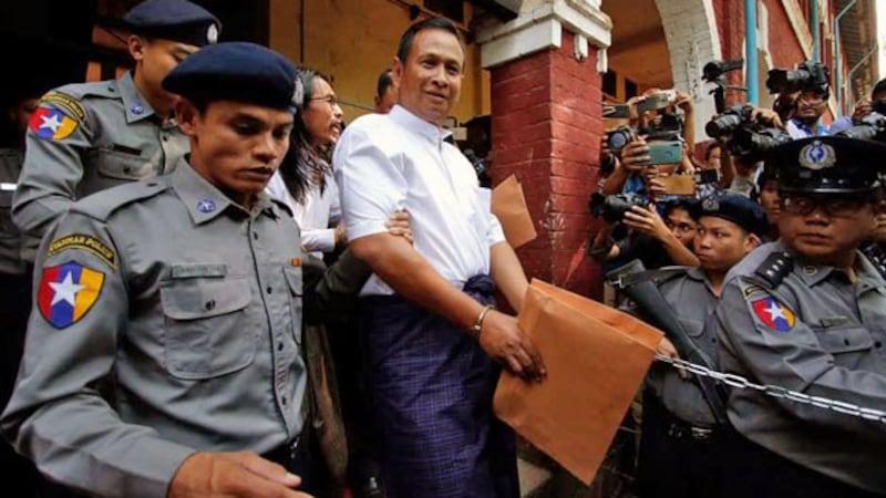 Aung Win Zaw (C), who helped plan the murder of prominent Muslim lawyer Ko Ni, is escorted by police from the Yangon Northern District Court in Yangon, Feb. 15, 2019.