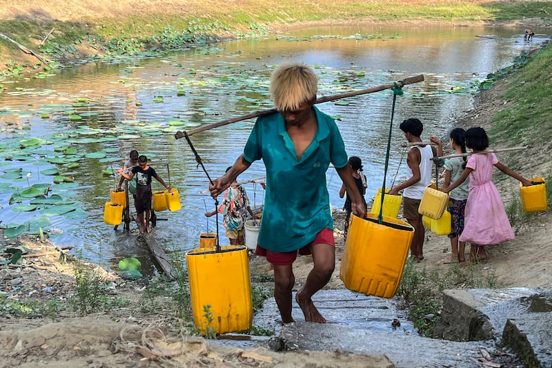 ရန်ကုန်မြစ်တစ်ဘက်ကမ်း ဒလမြို့နယ်တွင် နေထိုင်သည့် ပြည်သူများ သောက်သုံးရေခပ်ယူနေကြသည်အား ၂၀၂၃ ခုနှစ် မေလ ၂ ရက်နေ့က တွေ့ရစဉ်။ (Photo: RFA)