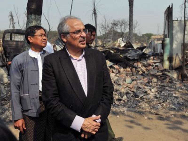 Vijay Nambiar (C), the United Nations special adviser on Myanmar, looks at destroyed buildings following an outbreak of communal violence in central Myanmar's Mandalay region, March 24, 2013.