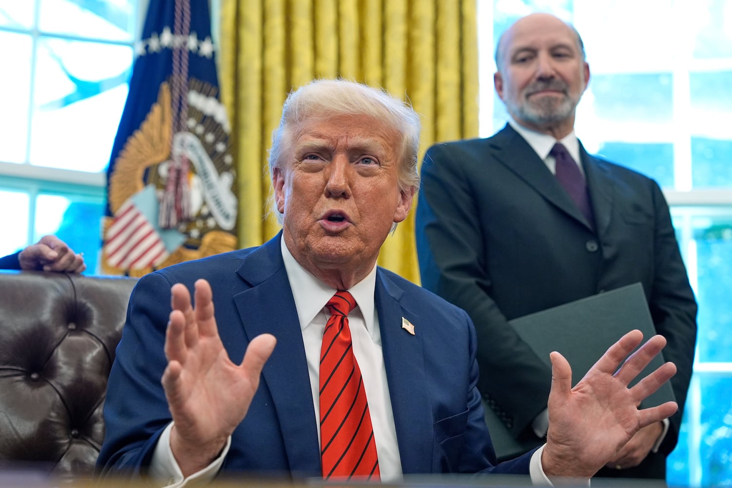 President Donald Trump to reporters in the Oval Office, April 17, 2025. At rear is Commerce Secretary Howard Lutnick.