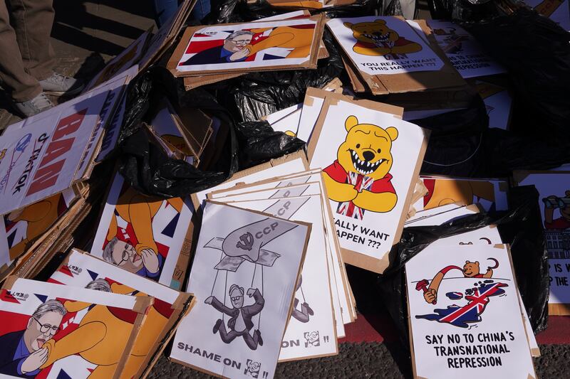 Signs depicting British Prime Minister Keir Starmer as well as Chinese President Xi Jinping as Winnie the Pooh await protesters at the proposed site of the Chinese “mega-embassy” in London, March 15, 2025.