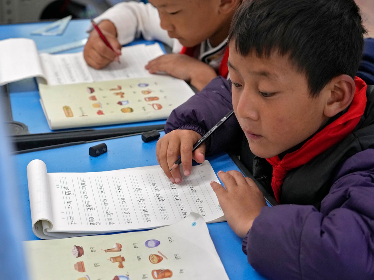 Tibetan students learn Tibetan writing in a first-grade class at the Shangri-La Key Boarding School in Dabpa county, Kardze Prefecture, Sichuan province, China, Sept. 5, 2023.