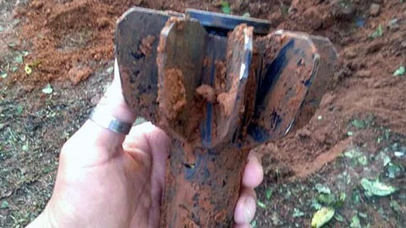 A Myanmar villager holds part of a mortar shell that fell in Pang Say village in Kutkai township, northeastern Myanmar's Shan state, Aug. 27, 2019.