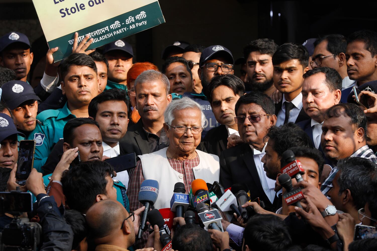 Muhammad Yunus (center) is seen as he exits a labor court that sentenced him to six months in jail for labor law violations in Dhaka, Jan. 1, 2024. (Mahmud Hossain Opu/AP0