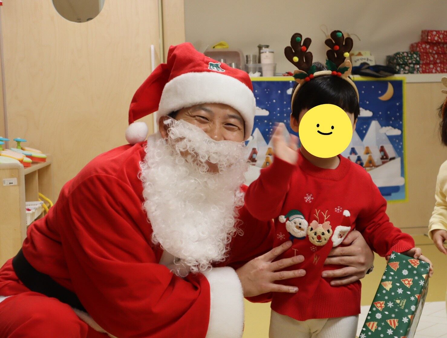 김남일 씨 아들이 유치원 크리스마스행사에서 산타와 기념 사진을 촬영하고 있다.