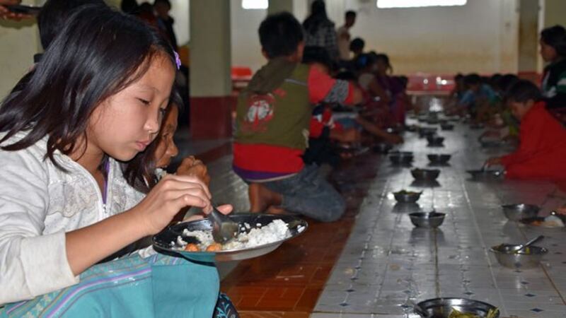 Children displaced by armed conflict in Myanmar's northern Shan state eat a meal at a shelter in Kutkai township, Aug. 22, 2019.