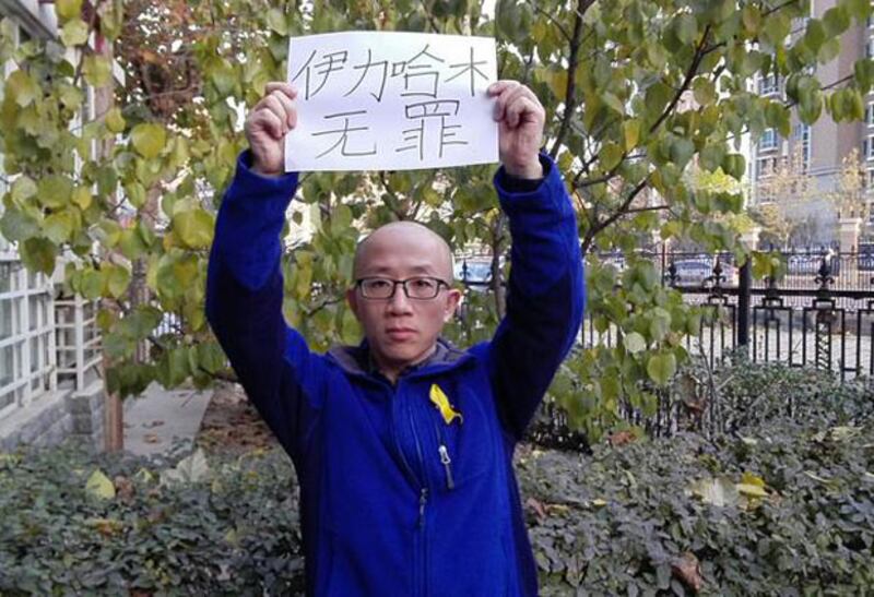 2014年11月21日，北京維權人士胡佳發布高舉“伊利哈木無罪”的標語的照片，聲援伊力哈木。（胡佳推特）