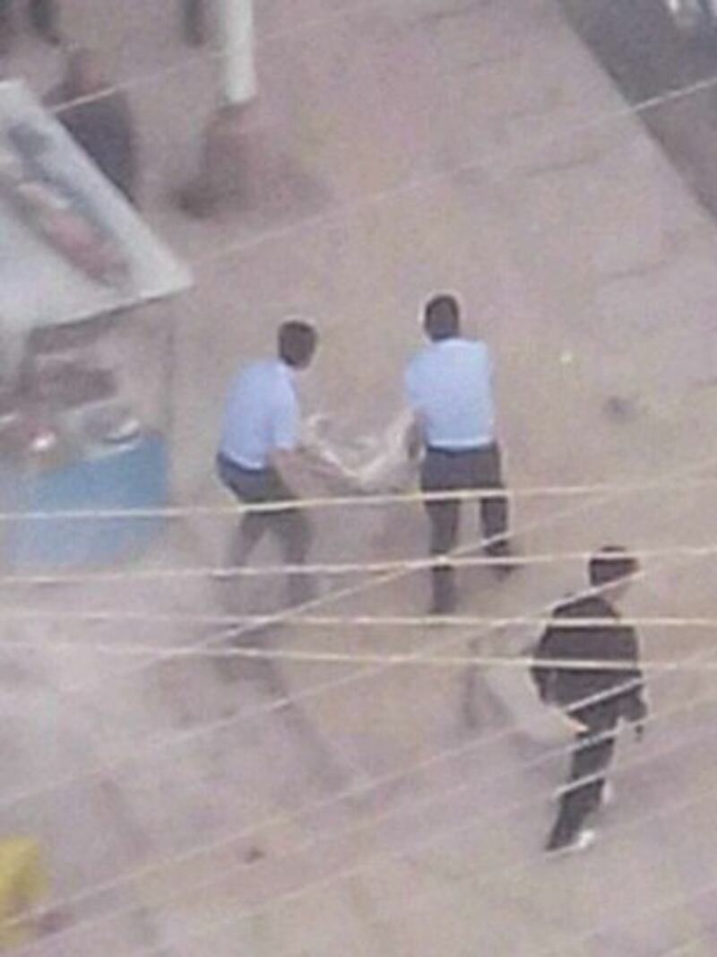 图片：四川阿坝警方8月13号抬走自焚藏人扎西。（达兰萨拉格尔登寺提供）