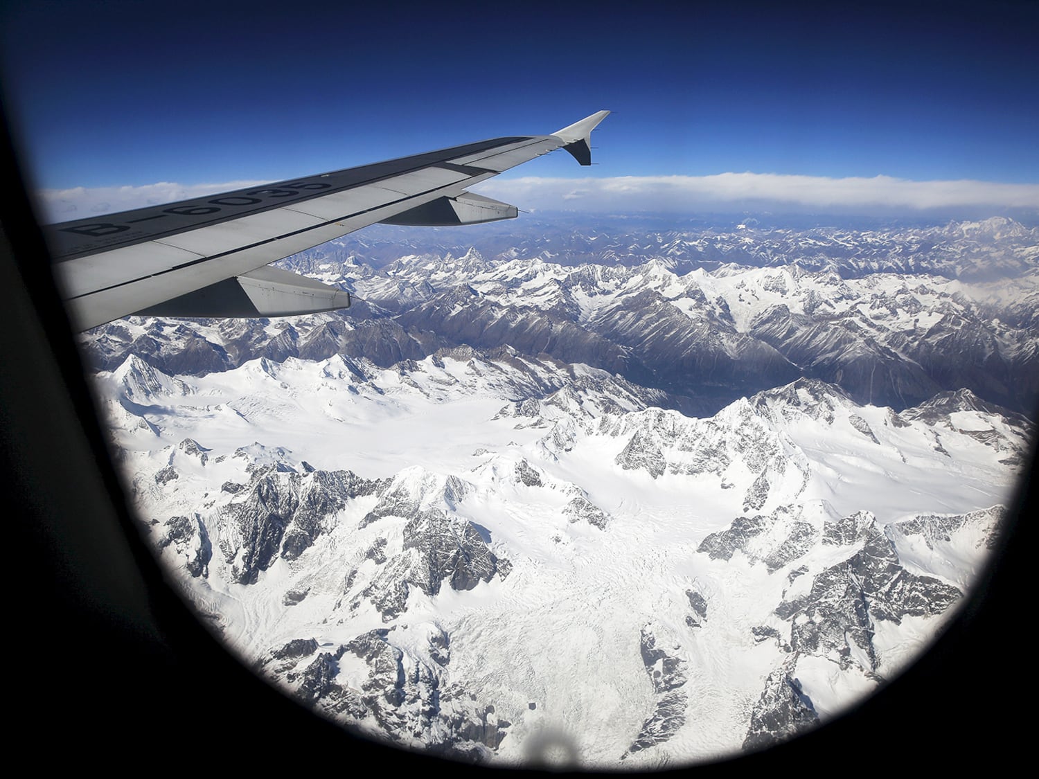 An airplane descends over mountains towards Lhasa, capital of Western China's Tibet Autonomous Region, Nov. 16, 2015.